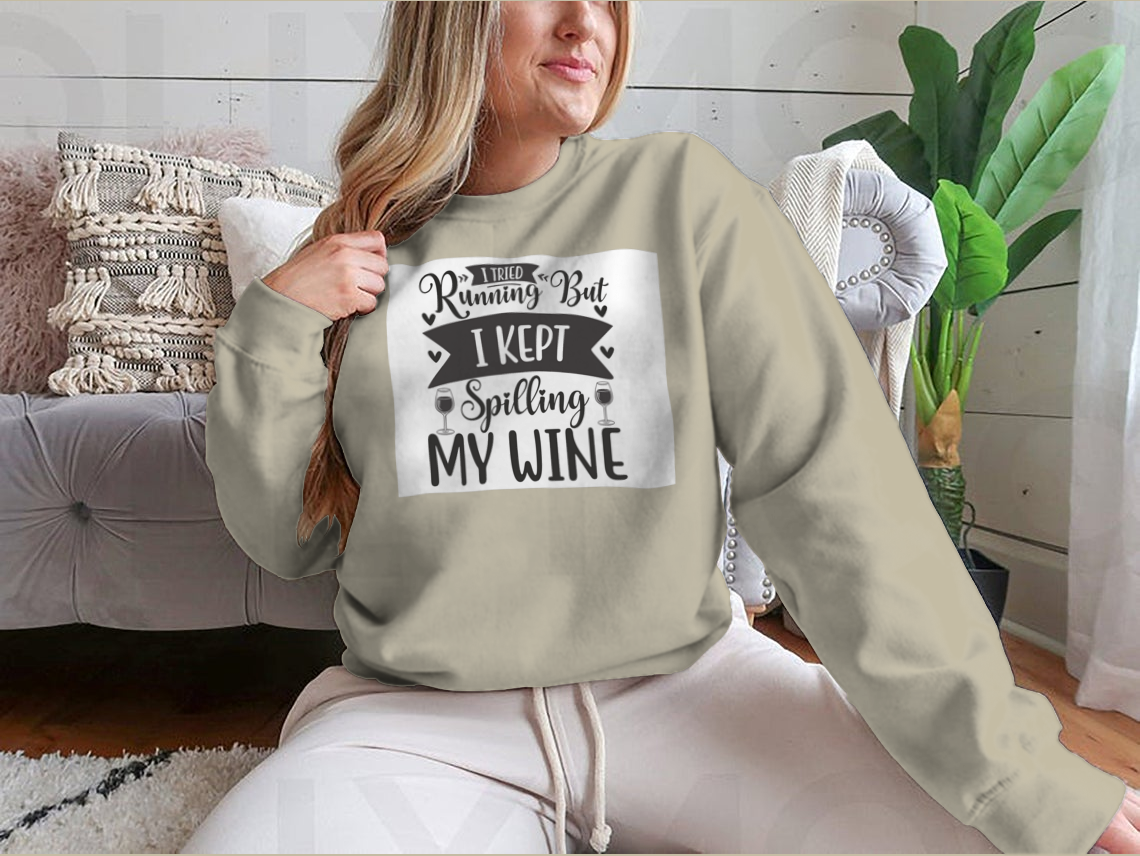 A cozy sweatshirt featuring the humorous phrase 'I Tried Running But I Kept Spilling My Wine', perfect for wine lovers.